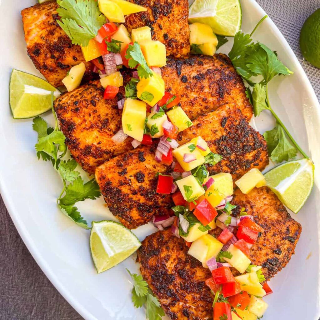 Blackened mahi on a platter with mango salsa.