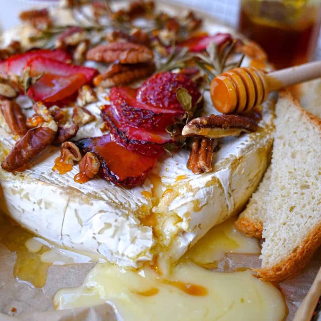 air fryer brie with strawberries rosemary pecans and honey