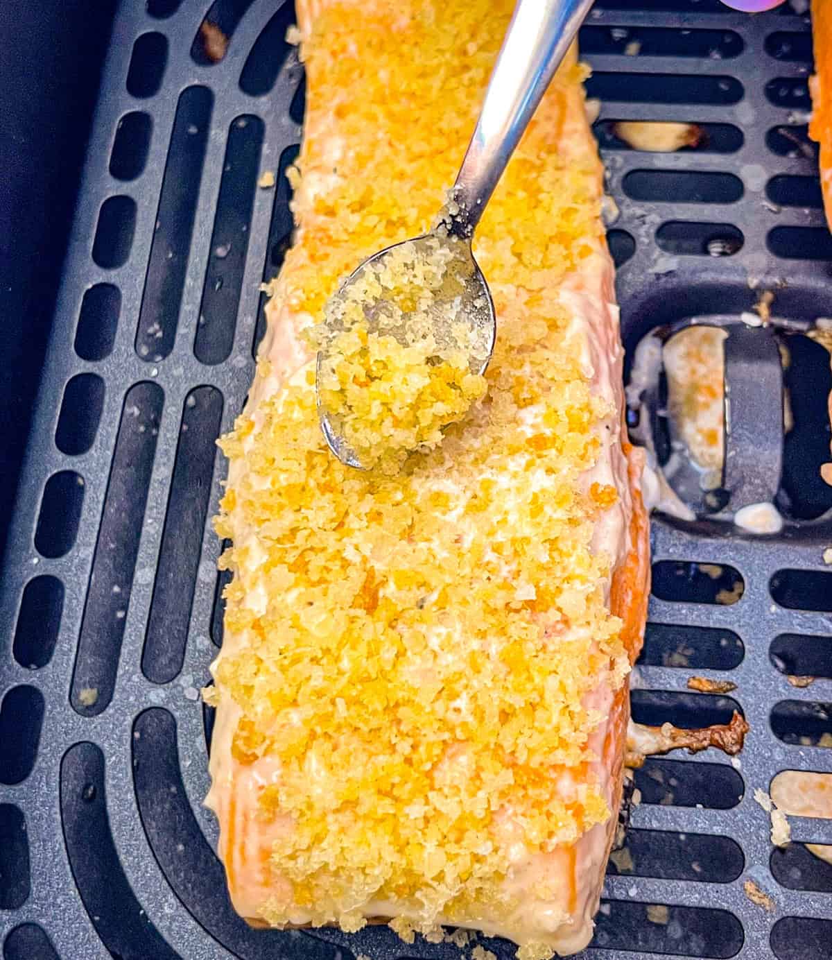 Une cuillerée de chapelure de panko saupoudrée sur le saumon.