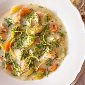 Tuna Chowder in a white bowl garnished with lemon an dill.