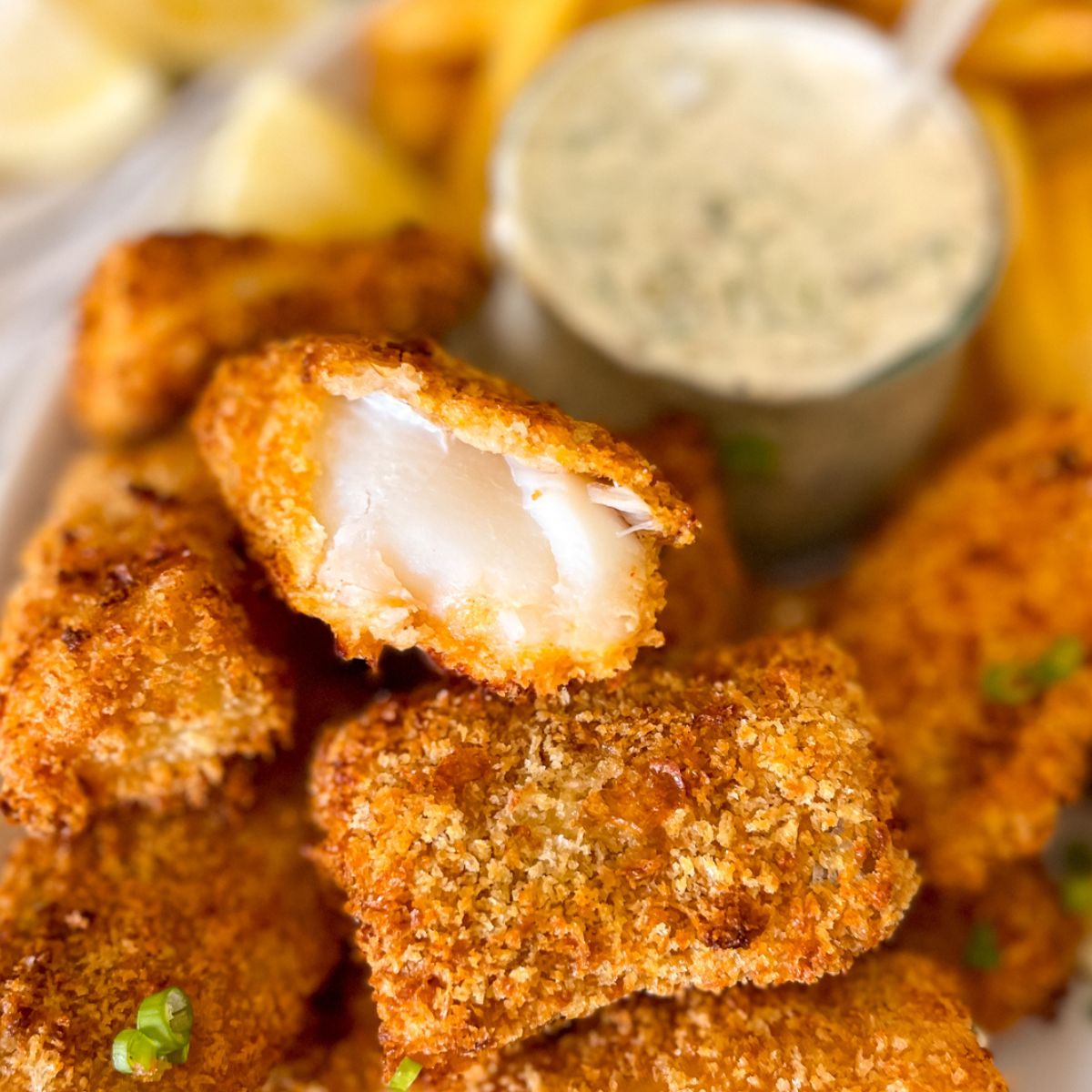 Fish stick in a bow with tartar sauce.