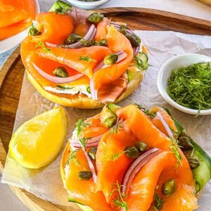 Smoked salmon and cream cheese bagel garnished with capers, dill and red onions.
