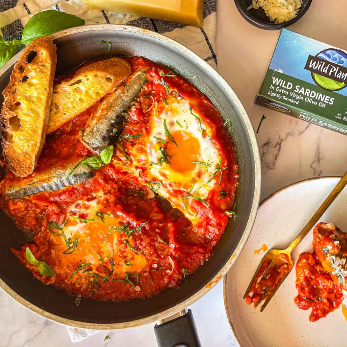 Sardine in purgatory laid out on a table.