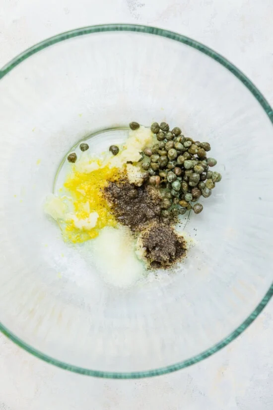 câpres, jus de citron, zeste de citron dans un bol