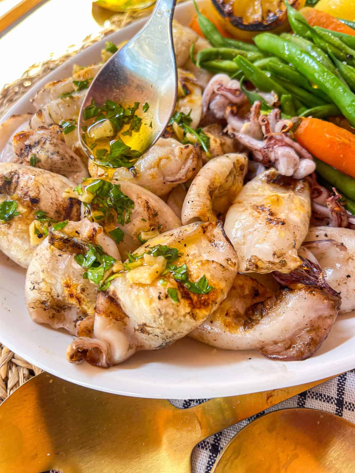 Sauce à l'ail et aux herbes arrosée de calamars grillés.