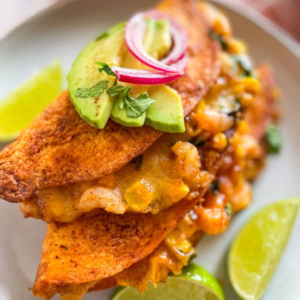 Quesadillas laid out on a white plate.