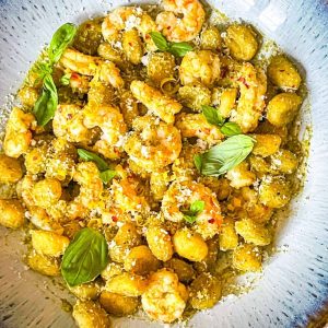 Bowl of pesto gnocchi with shrimp.