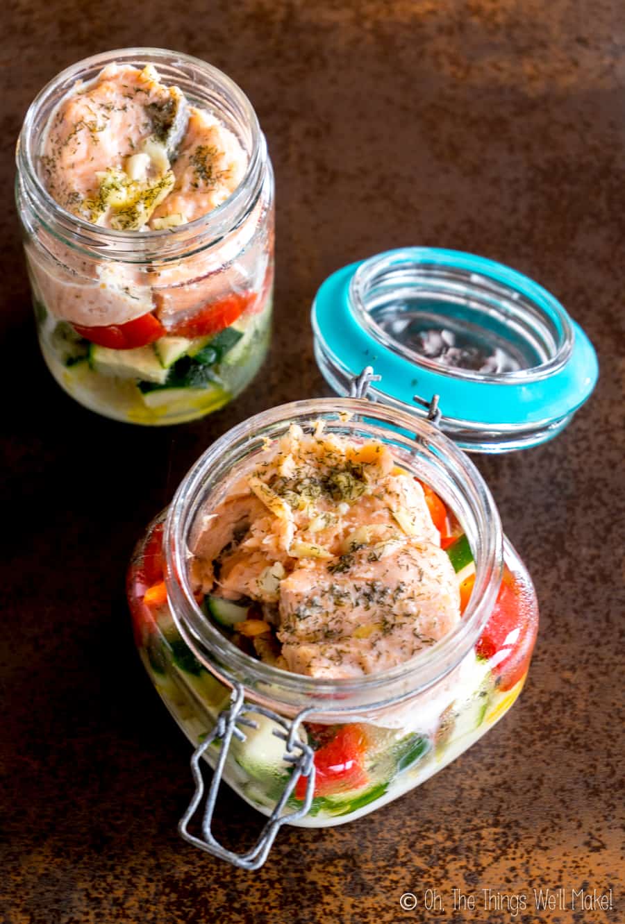 Vue aérienne du saumon et des légumes coupés cuits dans des bocaux au lave-vaisselle.