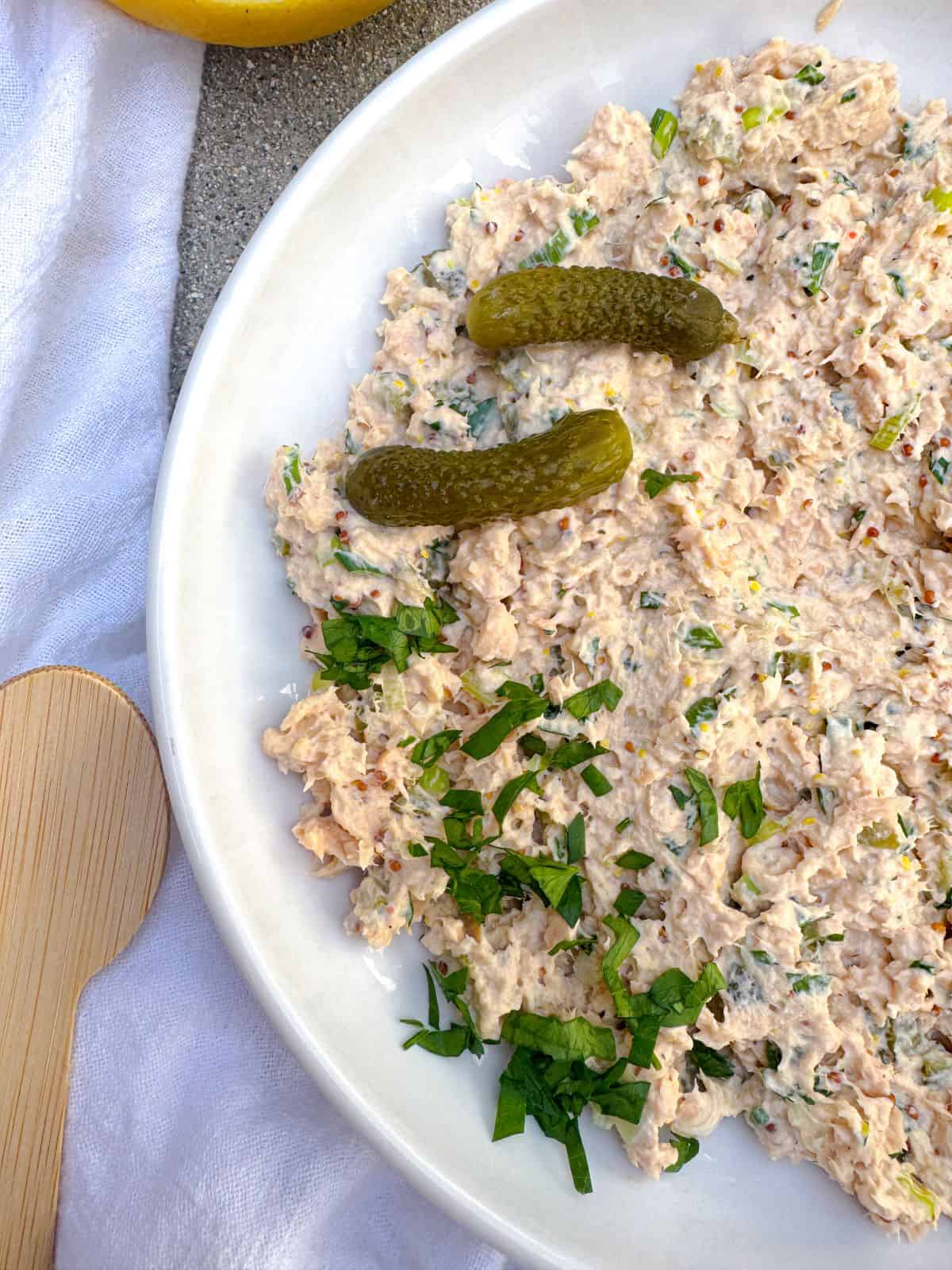 recette de salade de saumon en conserve avec cornichons sur une assiette blanche