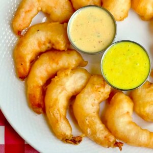 Beer Battered Shrimp photo of a platter of shrimp organized on a semi circle on a white platter, close up ohoto for Google featured image.